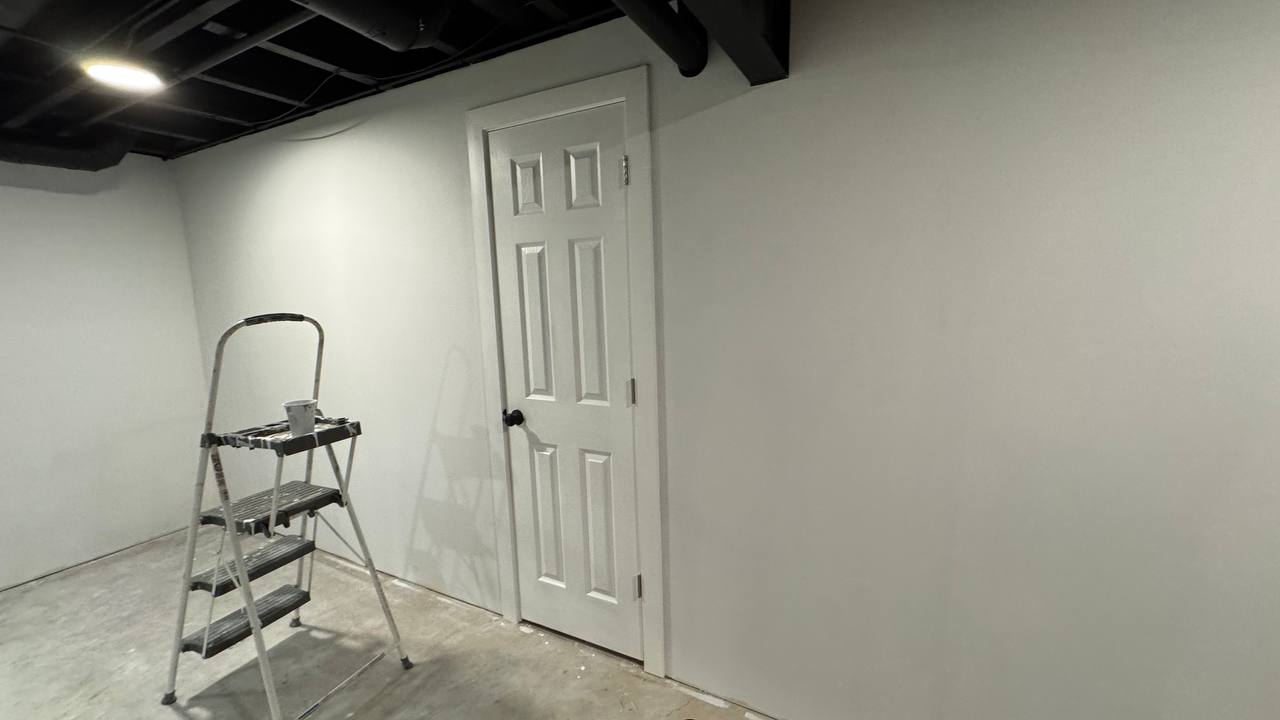 Doors, trim, and baseboards completed during a basement remodeling project.